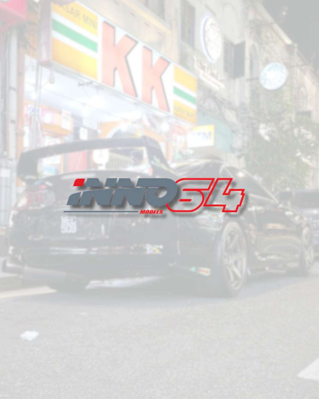 Inno64 logo overlay on a black sports car parked on a city street at night