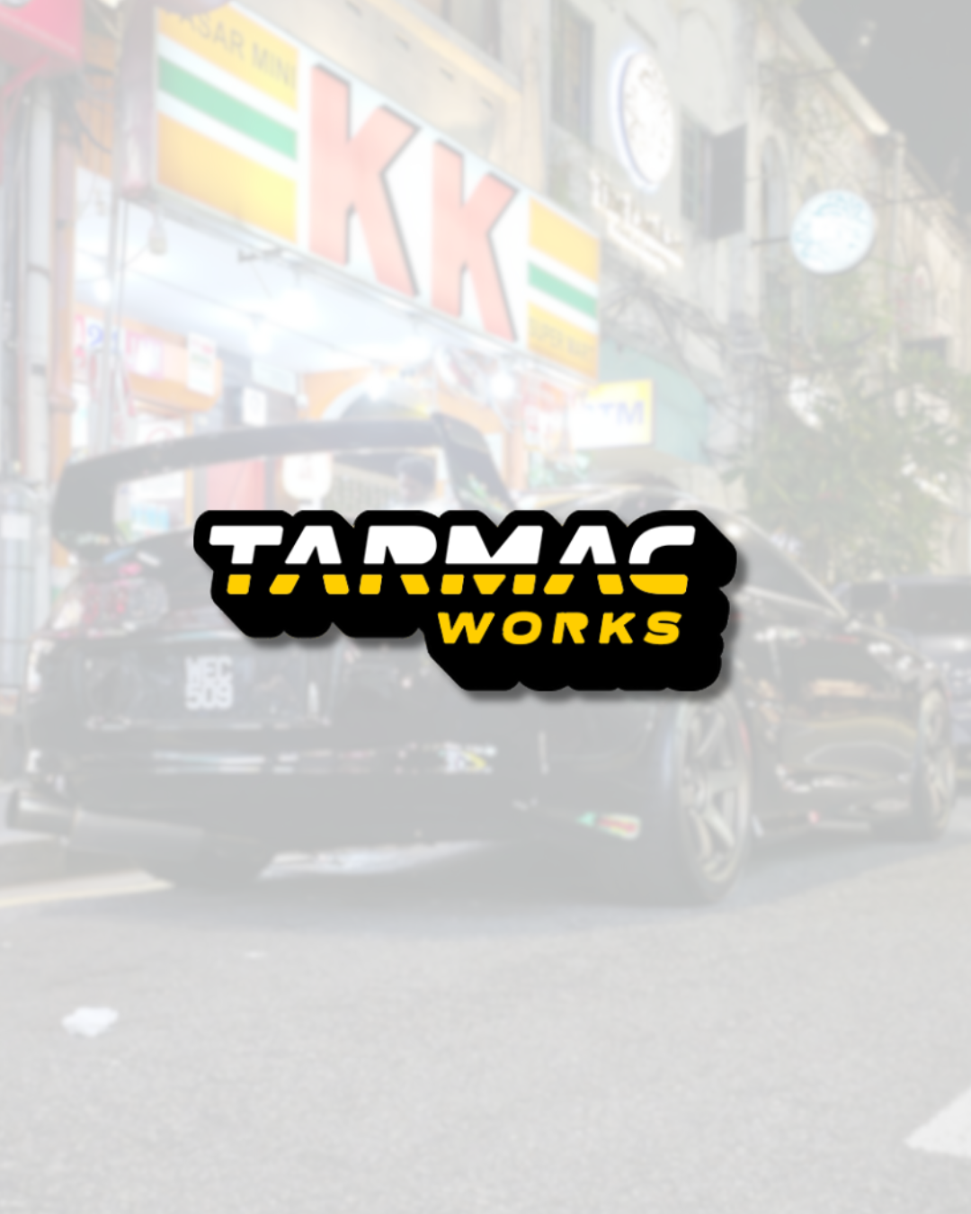 Tarmac Works logo overlay on detailed model car in urban nighttime setting